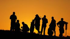 Golfers at dusk waiting to play