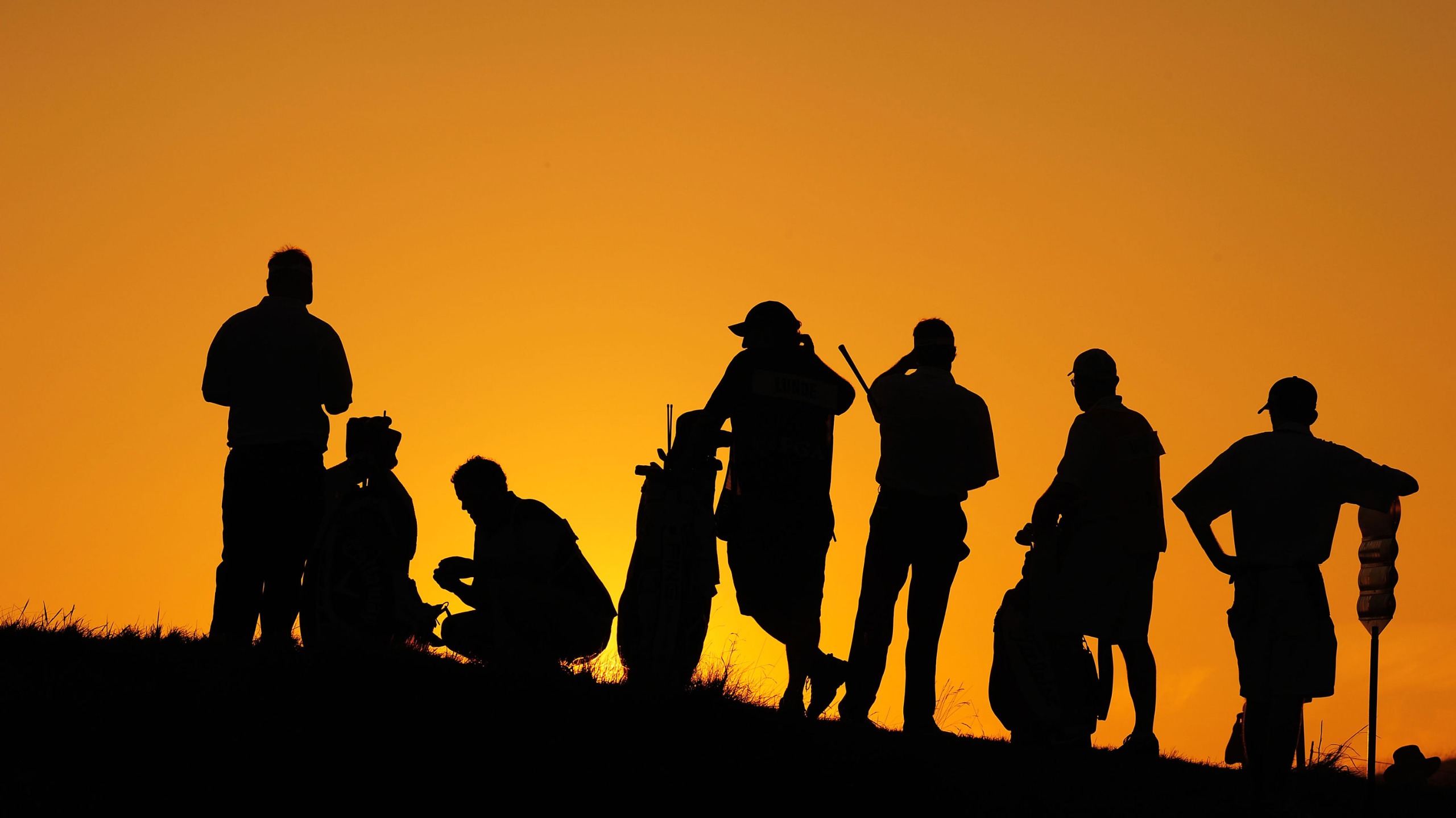 Golfers at dusk waiting to play