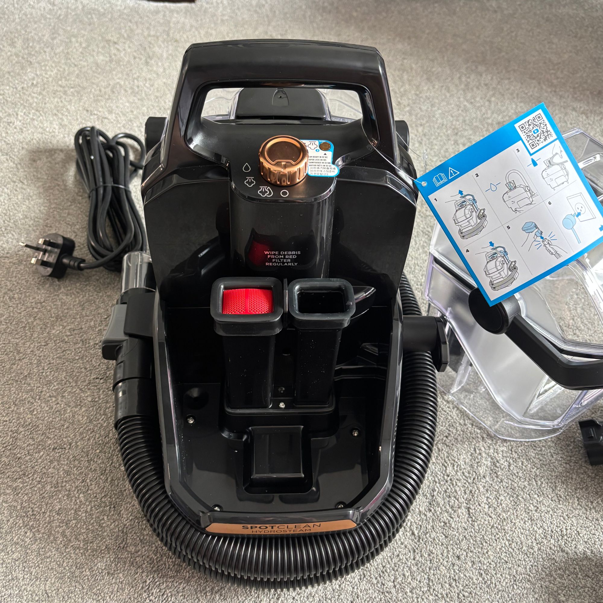Bissell SpotClean HydroSteam sitting on grey carpet