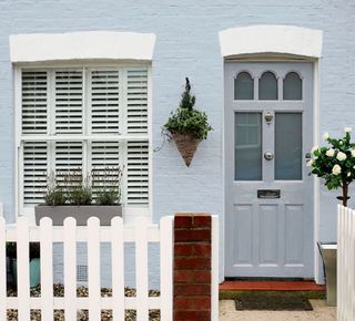 How to paint an exterior wall with pale blue paint and doorway