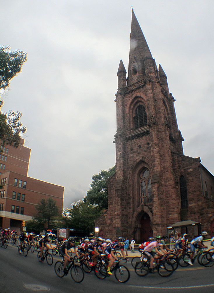 The peloton rolls off in front of the historic district.