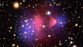A composite image of the Bullet Cluster, a much-studied pair of galaxy clusters that have collided head on. One has passed through the other, like a bullet traveling through an apple, and is thought to show clear signs of dark matter (blue) separated from hot gases (pink).