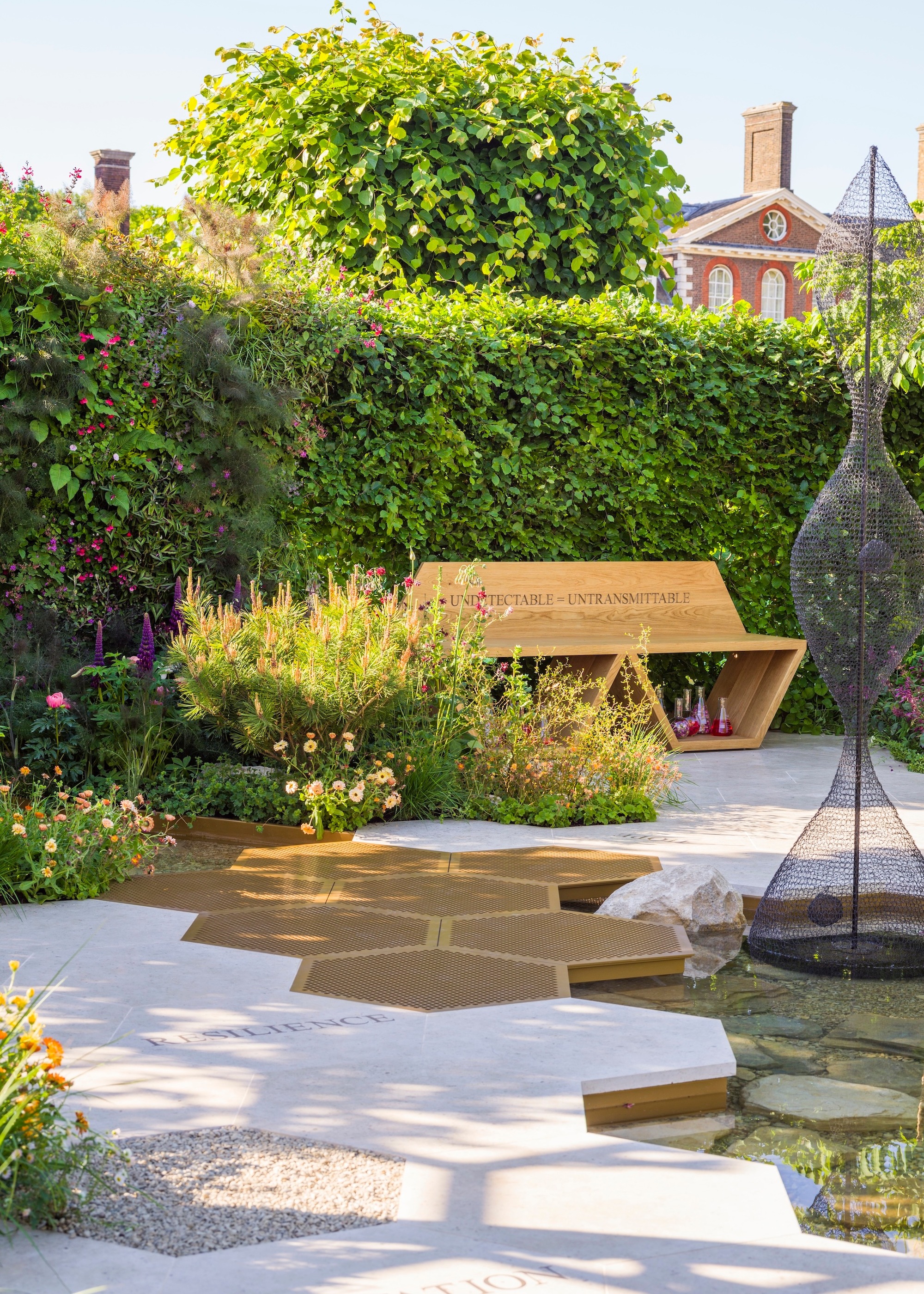 Hexagonal path leading to wooden bench at Chelsea Flower Show
