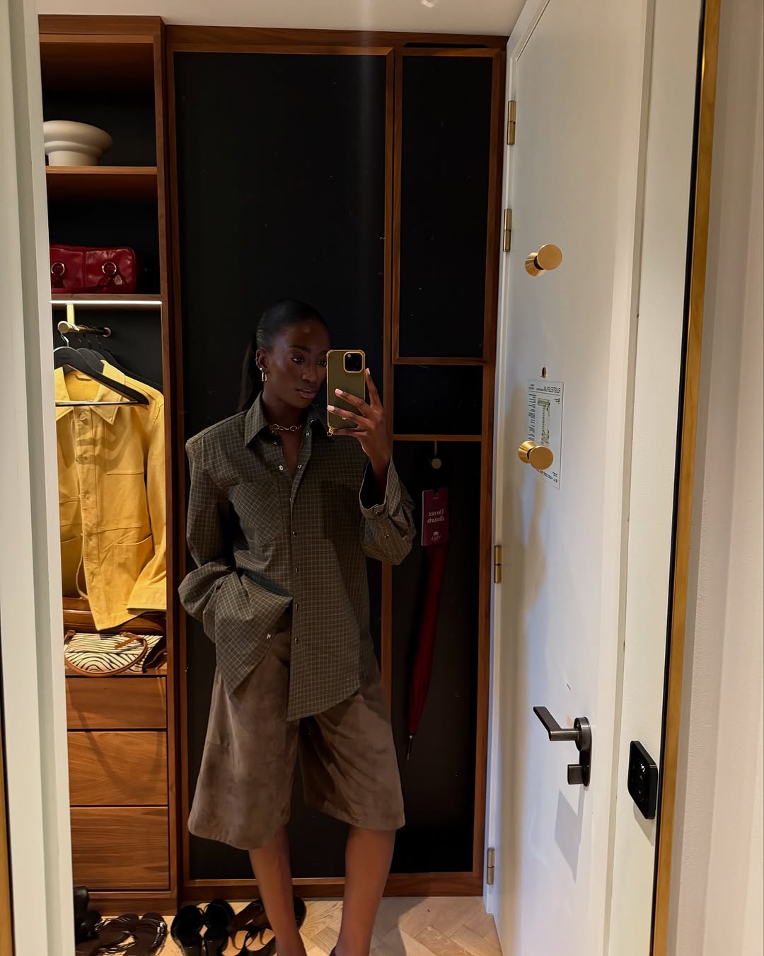 Woman wearing plaid jacket trend fall 2025.