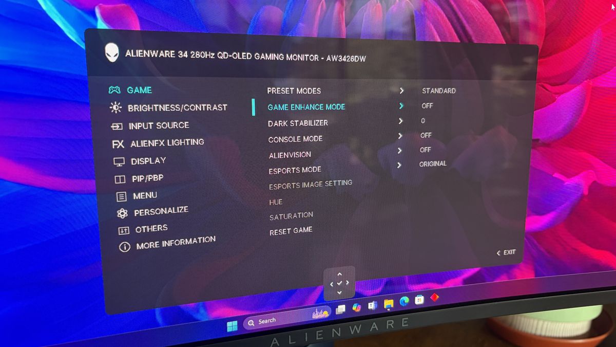 Alienware 34-inch QD-OLED gaming monitor settings menu displaying various display options against a colorful background.
