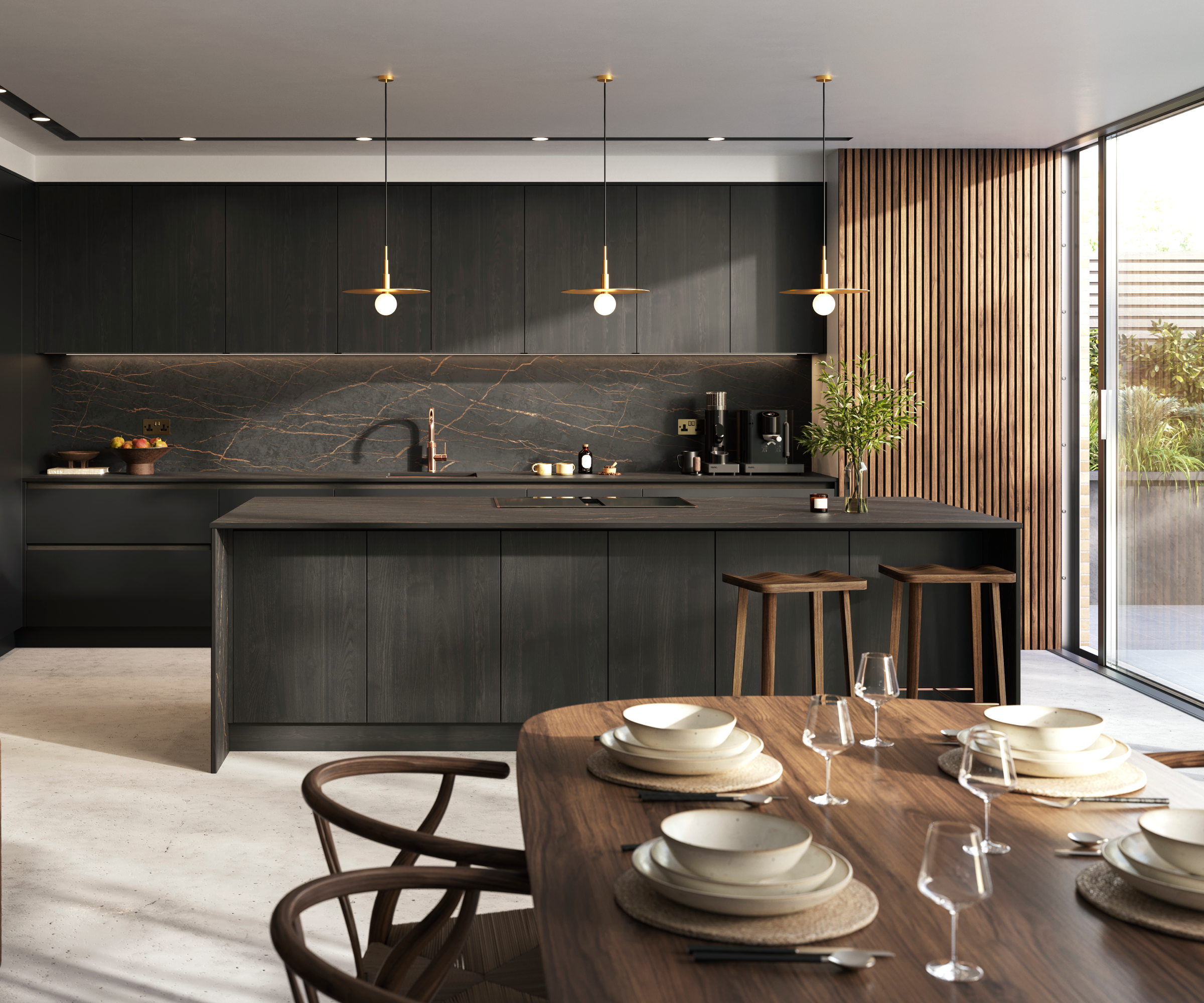 black wooden kitchen cabinets with vertical wood panelling on wall, large kitchen island and wooden dining table and chairs in front of large patio doors