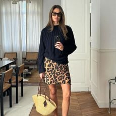 Anne Laure Mais wears a leopard print mini skirt