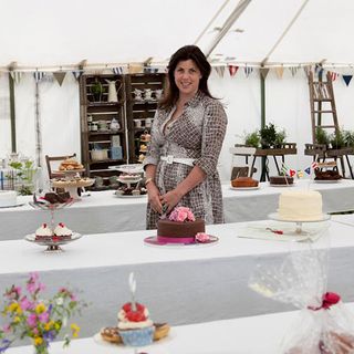 woman with white wall and cake