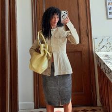 sami miro wearing a leather jacket and skirt, and yellow bag