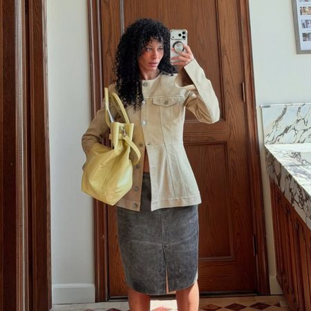 sami miro wearing a leather jacket and skirt, and yellow bag