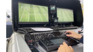 A video engineer controls the robotic JVC PTZ camera for West Virginia football games.