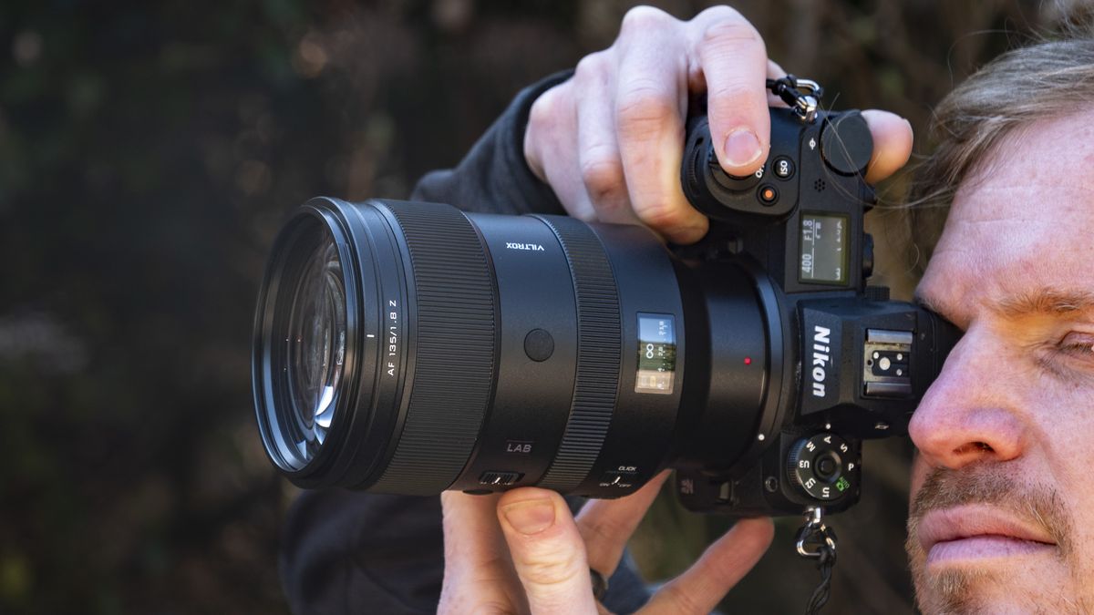 Viltrox 135mm F1.8 Lab lens for Nikon Z-mount, in the hand, attached to a Nikon Z6 II