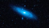 The nearby Andromeda galaxy with older stars highlighted in blue. A new theory of quantum gravity could help explain why more distant galaxies seem to be retreating faster than nearer ones.