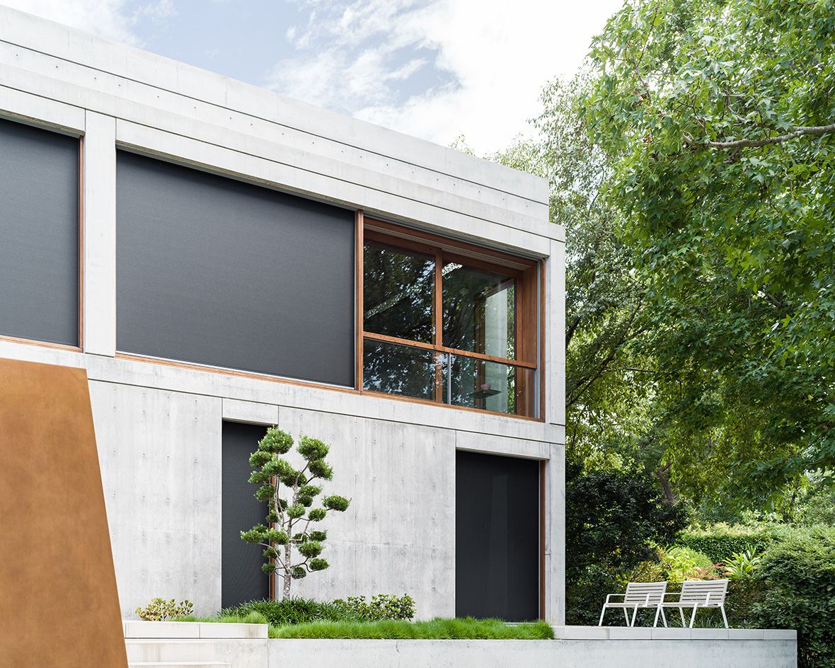 Treetops House concrete exterior with terrace and deck chair