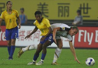 Abby Wambach (R 20#) of USA battles for the ball with Formiga (L 8#) of Brazil during the Womens World Cup 2007 Semi Final match between USA and Brazil at Hangzhou Dragon Stadium on September 27, 2007 in Hangzhou, Zhejiang province of China. (Photo by Feng Li/Getty Images)