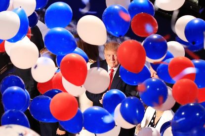 Balloons fall around Donald Trump at the RNC