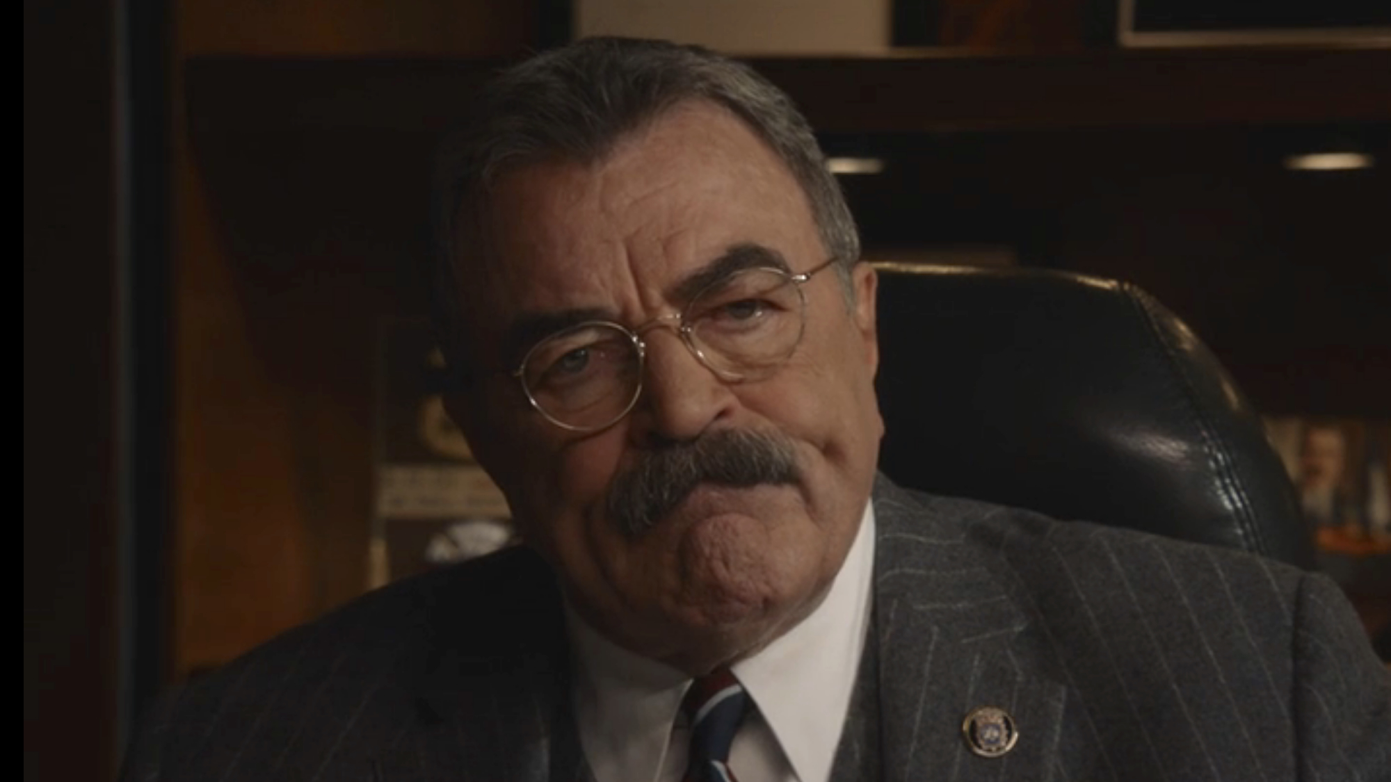 Frank Reagan with scrunched-up mouth in his office in Blue Bloods Season 13
