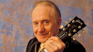 Les Paul holding a Gibson Les Paul Standard