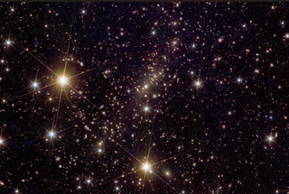 Another dark region of space with lots of light speckles of varying sizes. Some larger ones toward the left and bottom of the image, and generally around, have diffraction spikes visible.