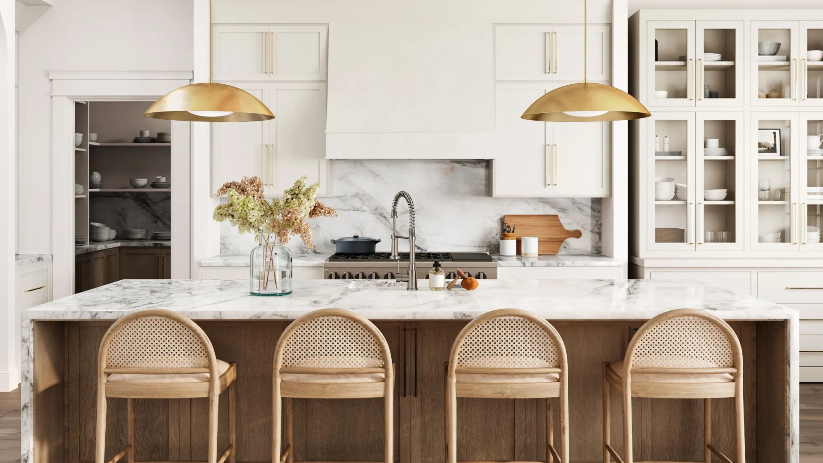 A white kitchen with a wooden island and cane back barstools