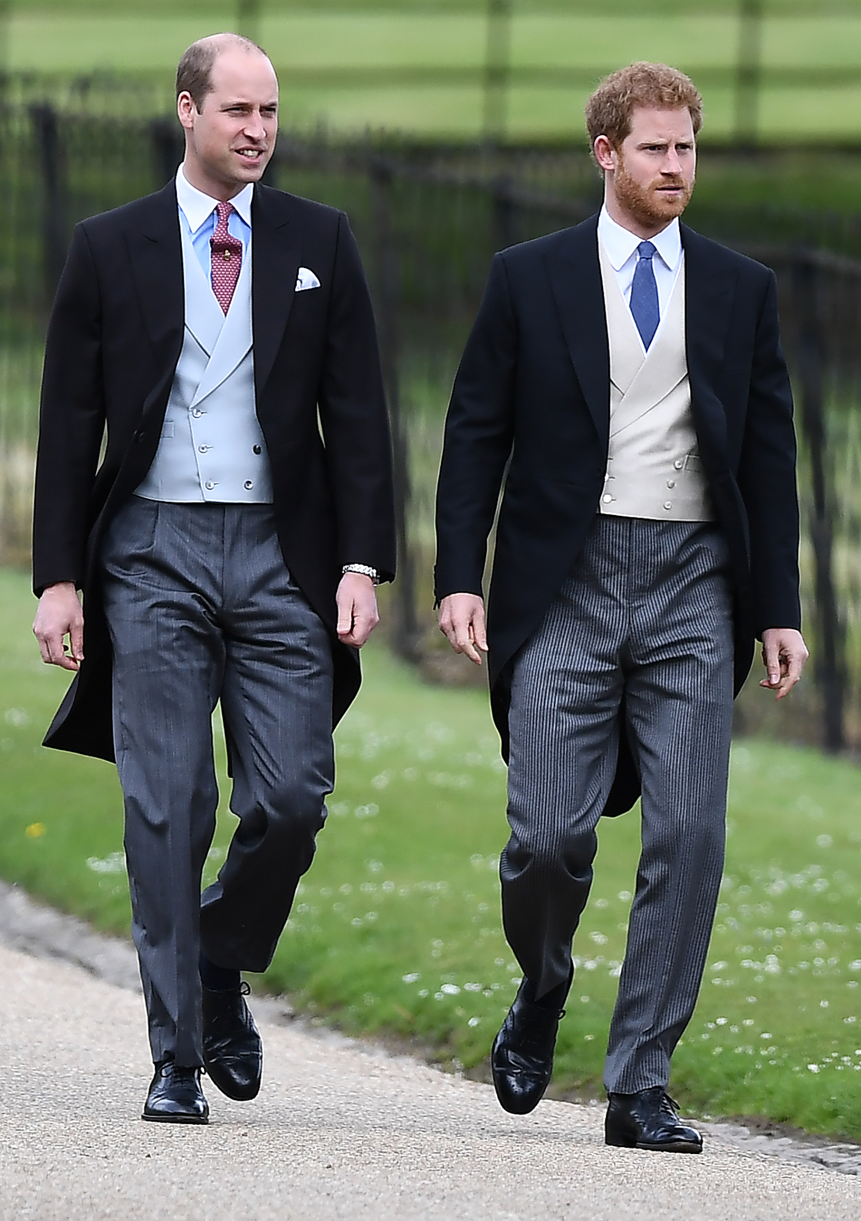 Prince William and Prince Harry both wearing suits, white shirts, and ties