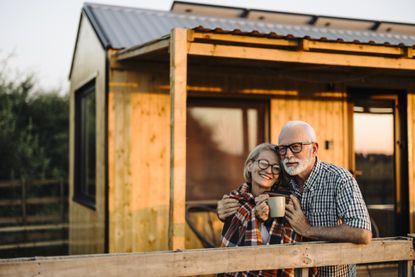 Happy couple on their vacation and spending the evening on the cabin patio