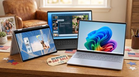 Three Dell laptops are on a wooden table with American flag decorations. One displays a colorful abstract graphic, another a website, and a third shows a skydiver photo. A "Memorial Day Sale" tag is in the foreground, creating a festive and tech-focused atmosphere.