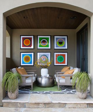 beige porch with colorful artwork on wall