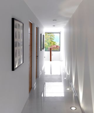 A hallway with a large picture window at the end