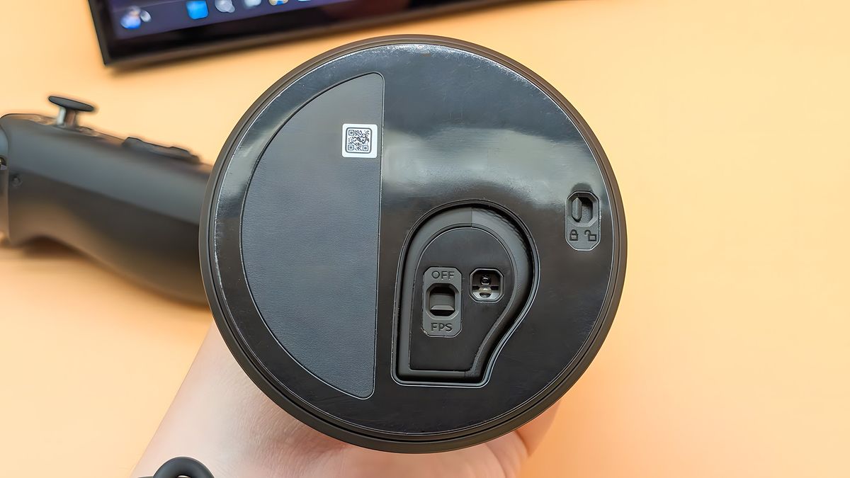 The underside of the FPS mode base with the right Lenovo Legion Go 2 controller locked into it. There is a switch for releasing the controller and another switch for turning FPS mode on and off.