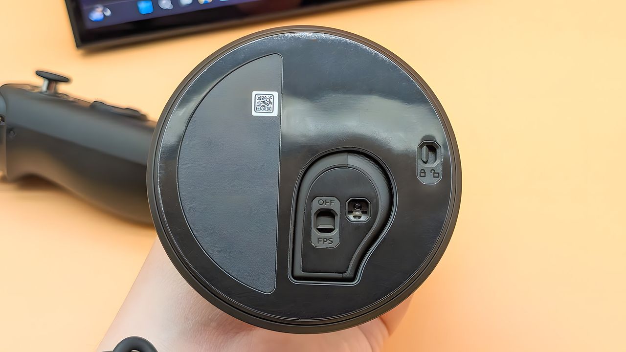 The underside of the FPS mode base with the right Lenovo Legion Go 2 controller locked into it. There is a switch for releasing the controller and another switch for turning FPS mode on and off.