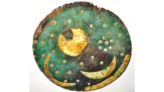 This photograph shows the Nebra Sky Disk before restoration work was carried out on it at the State Museum for Prehistory at Halle. It shows the corrosion and damage to the desk, including a fragment of gold missing from the circle near the center.