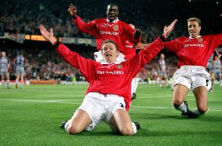 Ole Gunnar Solskjaer of Manchester United celebrates by doing a knee slide, followed by teammates Ronny Johnsen and Dwight Yorke, after scoring the winning goal in the 1999 UEFA Champions League final at the Camp Nou, Barcelona