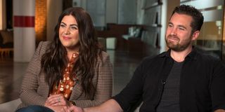 Hillary Scott from Lady A and her husband Chris Tyrrell sitting for an interview while holding hands.