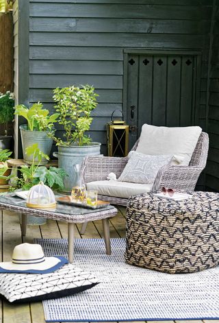 styling on decking with outdoor rug and chair