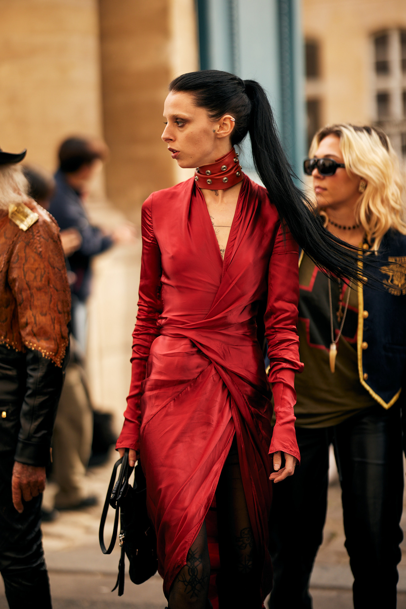a woman in a red dress with a long brunette ponytail