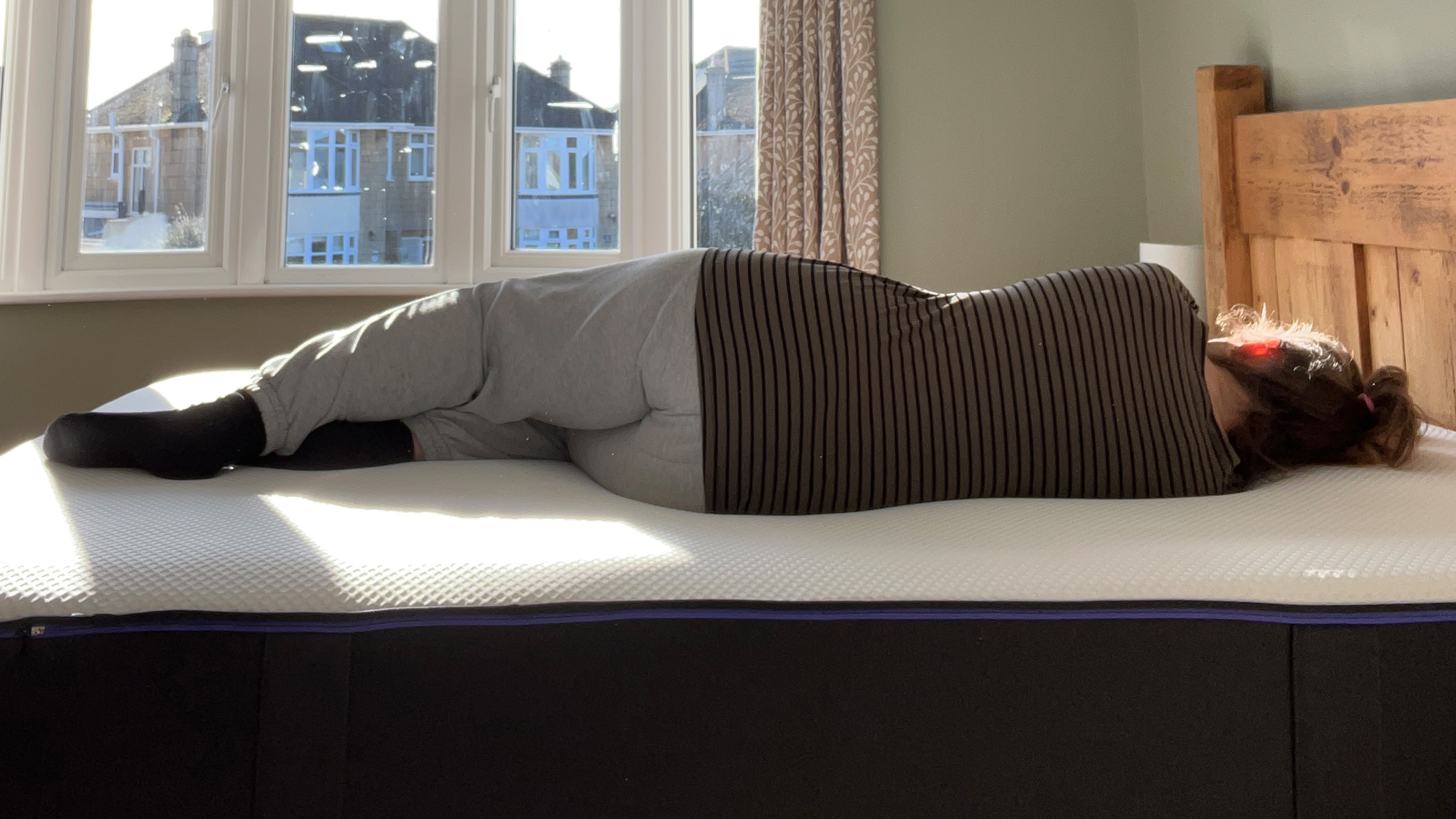 The Nectar Premier Hybrid Mattress being tested at home by a woman sleeping on her side