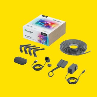 A Nanoleaf lighting kit with all the components on a yellow background.