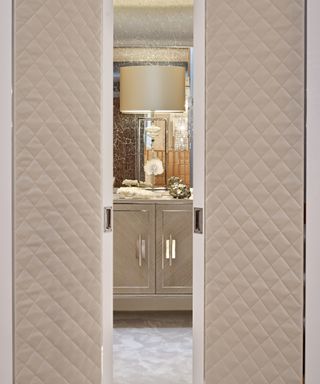 Luxury interior with padded fabric privacy doors into bathroom