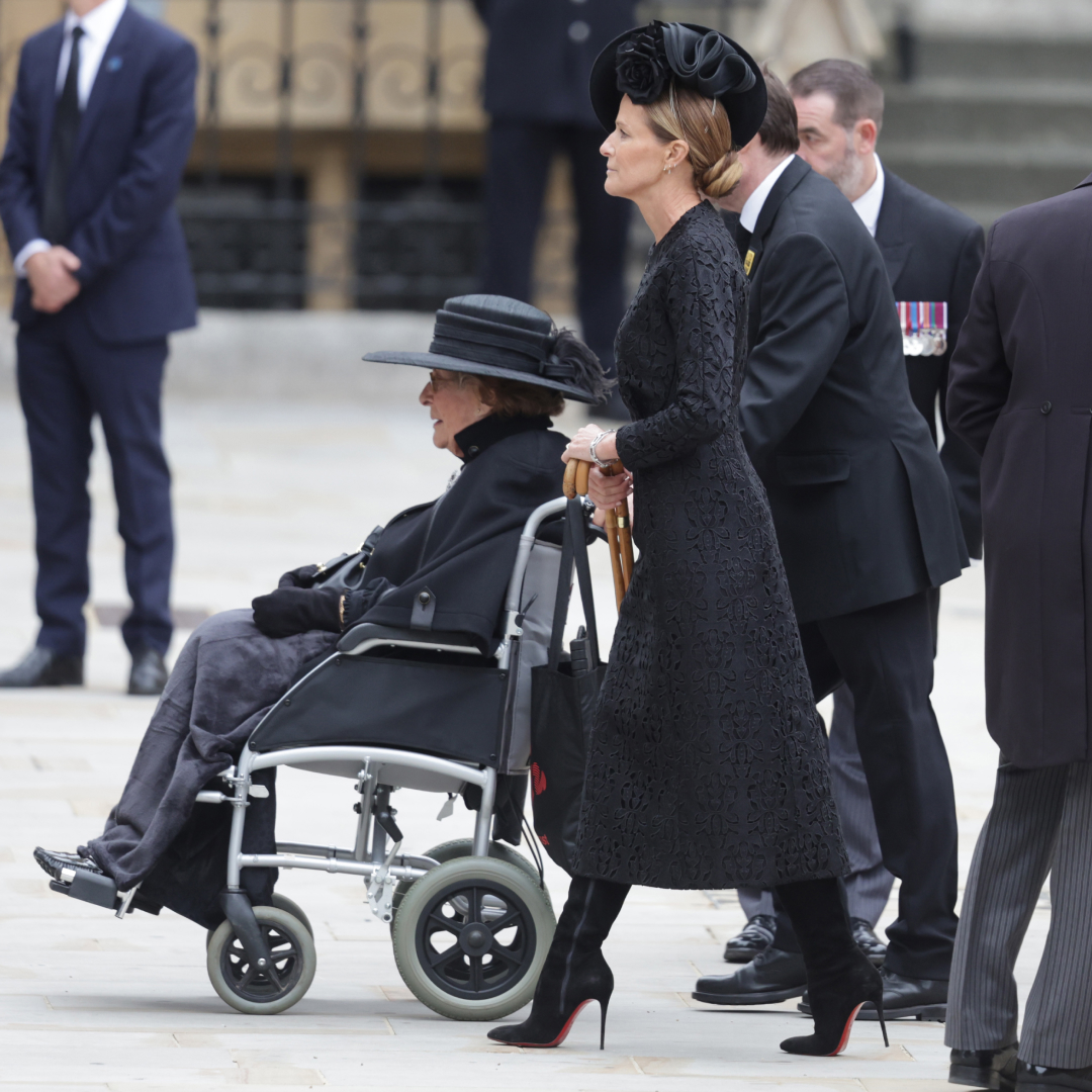 India Hicks walking behind Lady Pamela Hicks in a wheelchair at Queen Elizabeth's funeral