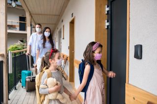 family arriving at hotel room to go on holiday without quarantine