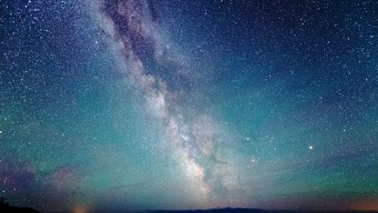 The milky way over Lake Superior with air glow and aurora borealis luminescence.