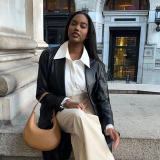 @melissareannejohnson wearing a white shier, leather blazer and tailored trousers