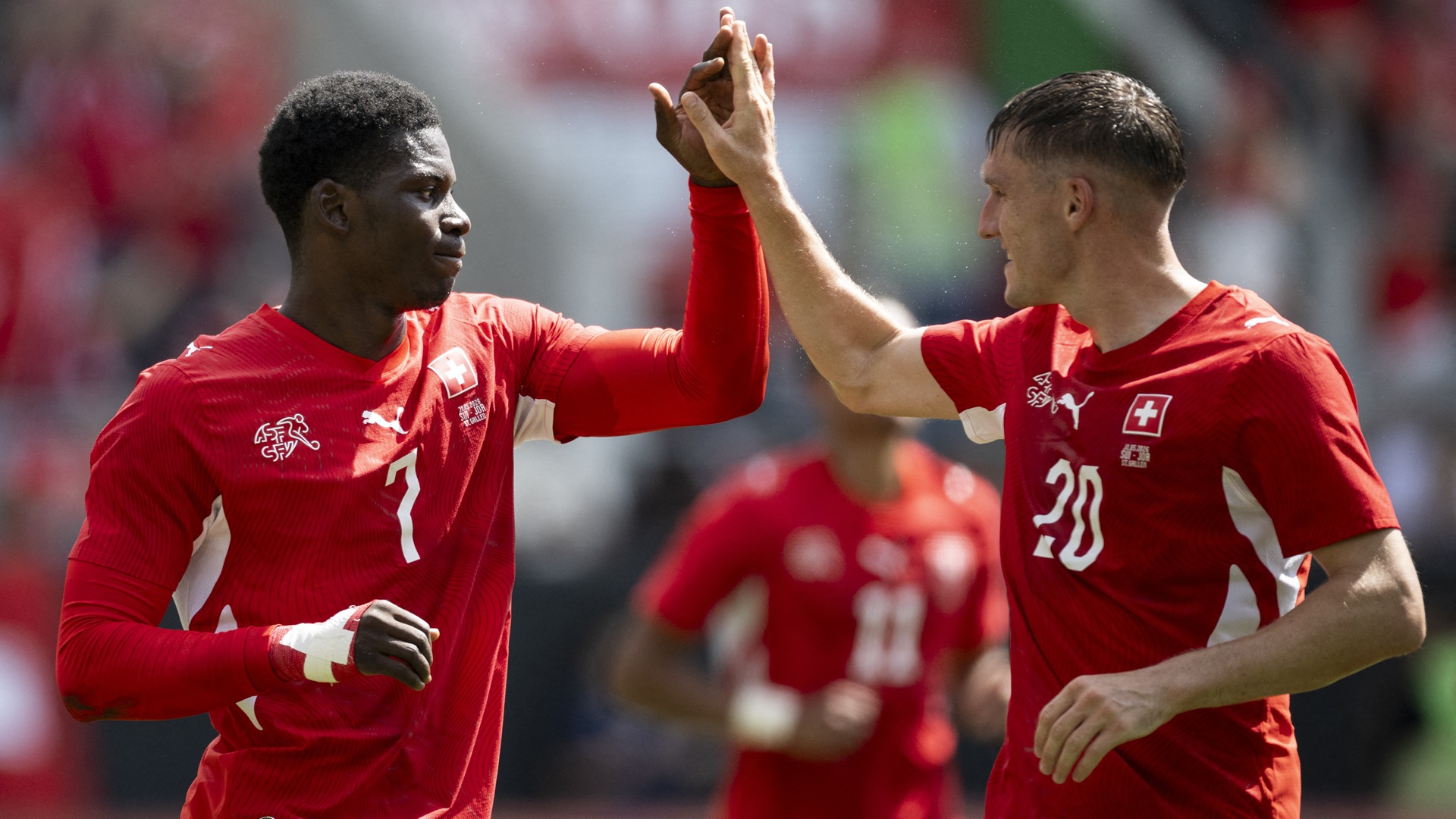 Switzerland's forward #7 Breel Embolo (L) celebrates with Switzerland's midfielder #20 Michel Aebischer scoring his team's first goal during a friendly football match between Switzerland and Jordan ahead of the 2026 FIFA World Cup football tournament at the Kybunpark stadium in St. Gallen on May 31, 2026. (Photo by Ennio LEANZA / AFP via Getty Images)