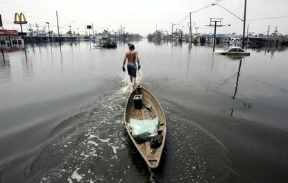 A New Orleans resident looks for survivors of Hurricane Katrina.