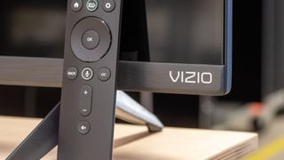 Vizio TV with remote in front on desk