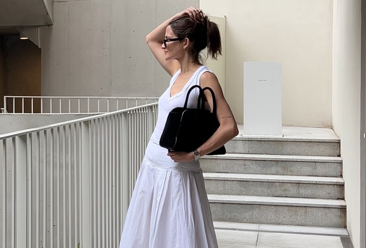 Eliza Huber in Seoul, South Korea wearing a white Zara tank top, white poplin skirt by Lafayette 148, a black COS bag, and black Studio Amelia sandals.