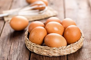 Eggs in a basket on a table.