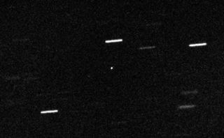 The dot at the center of this image is 'Oumuamua, an object with unusual properties that moved through the solar system in 2017. Scientists never got a much better look at it than this, an issue that has helped seed an ongoing high-profile controversy. This image was taken on OCt. 28, 2017 with the William Herschel Telescope in the Canary Islands.