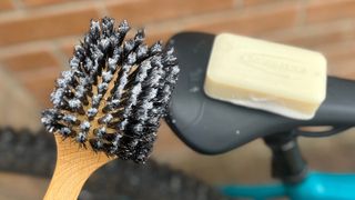 Brush and bike soap on bike saddle